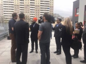 Jagmeet Singh talks with Indwell CEO Jeff Neven with reports present at Indwell's Parkdale Landing in Hamilton