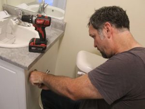 Graham Cubitt preparing an apartment bathroom at Woodfield Gate prior to opening
