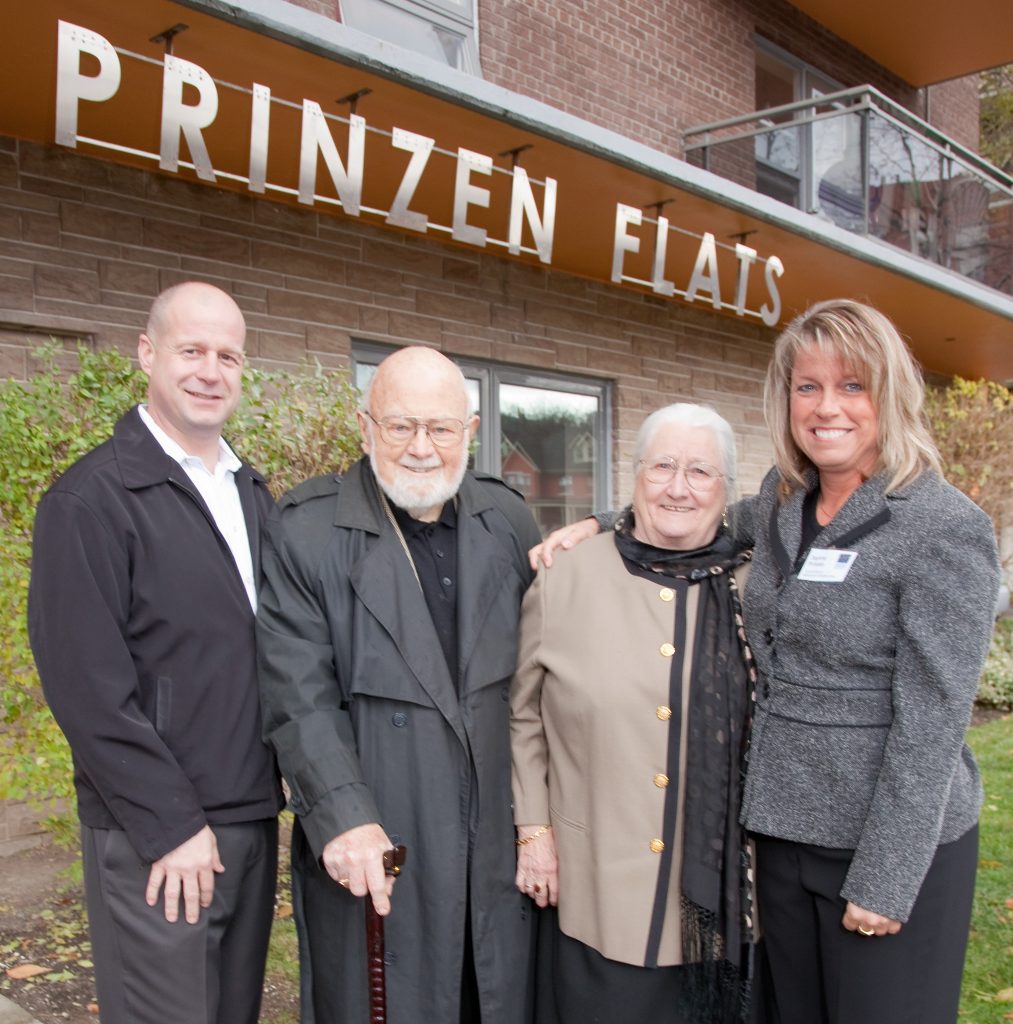 The Prinzen family (John and Siny, centre) in front of Prinzen Flats