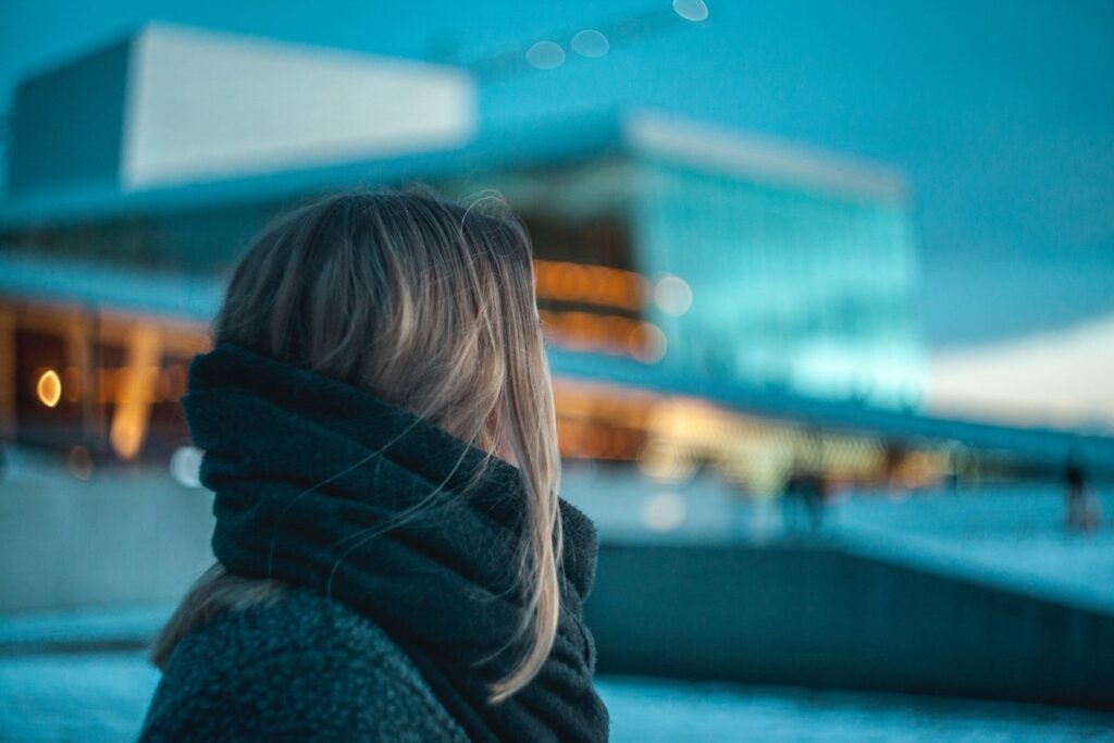 Woman looking at apartment building