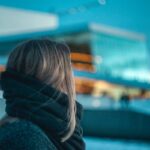 Woman looking at apartment building
