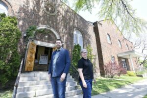 Sean McGuire, pastor, and Teresa Howe (Indwell) standing in front of Wentworth Baptist Church building