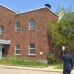 Sean McGuire, pastor, and Graham Cubitt (Indwell) standing in front of Wentworth Baptist Church building