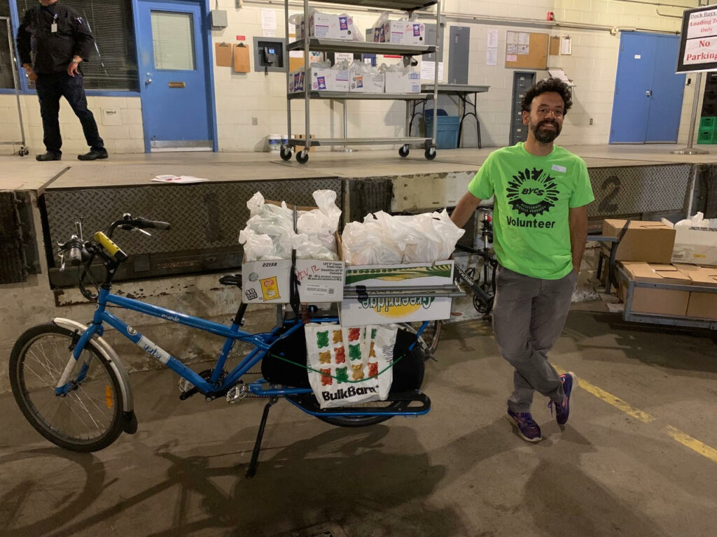 Luis, board chair of London Cycle Link, using his cargo bike to deliver meals to agencies distributing food to those in need during the pandemic