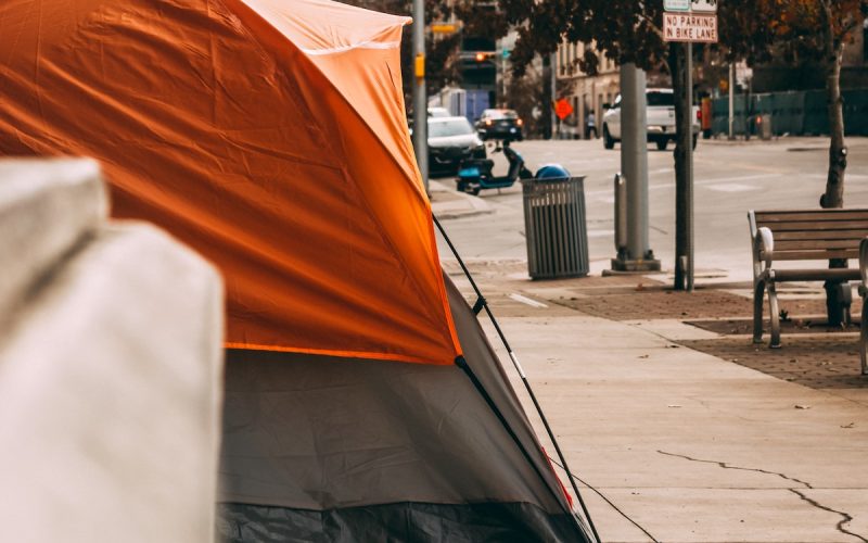 Tent on Street Homelessness - picture of Orange and grey tenant on a city sidewalk
