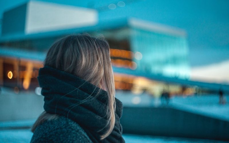 Woman looking at apartment building Woman looking at apartment building